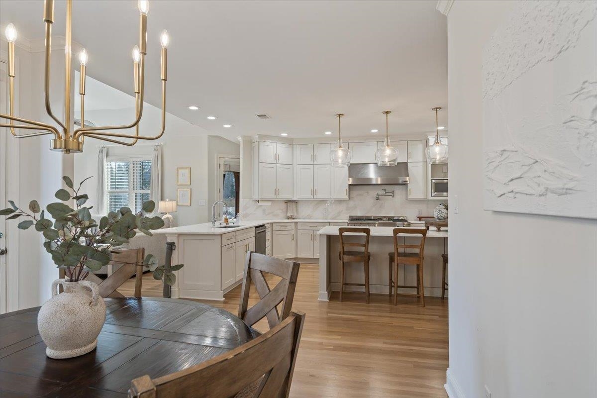 9455 Johnson Rd Extension Germantown, TN 38139 - Photo 13 of 40 Dining space featuring light wood-type flooring and a chandelier
