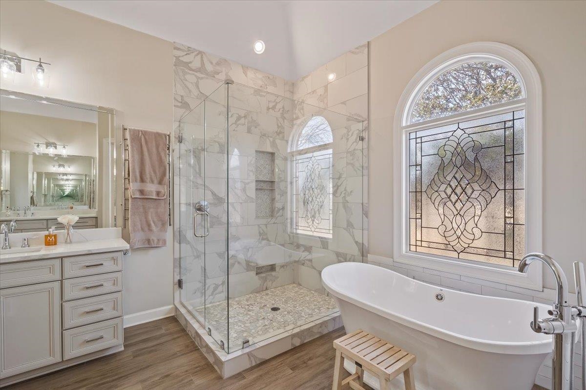9455 Johnson Rd Extension Germantown, TN 38139 - Photo 21 of 40 Full bathroom featuring a marble finish shower, a freestanding tub, vanity, and wood finished floors