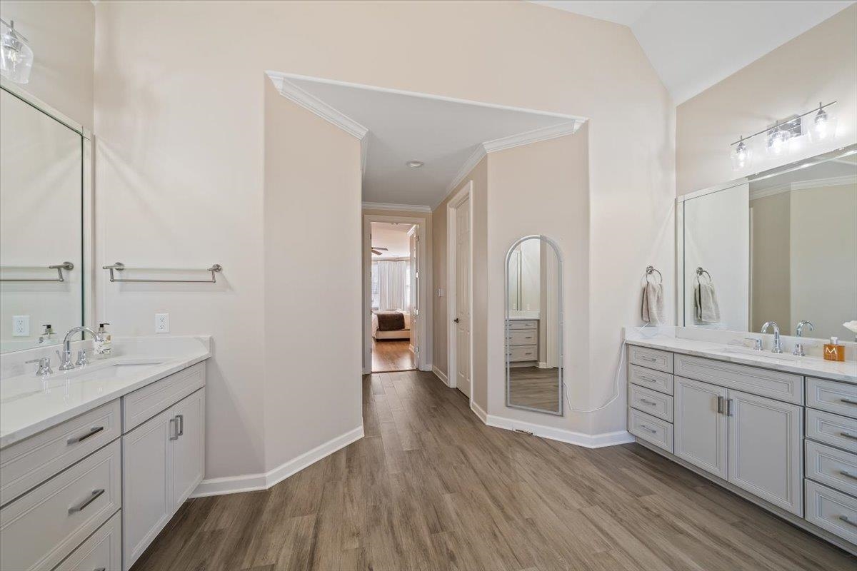 9455 Johnson Rd Extension Germantown, TN 38139 - Photo 22 of 40 Full bathroom featuring two vanities, ornamental molding, and dark wood-style floors