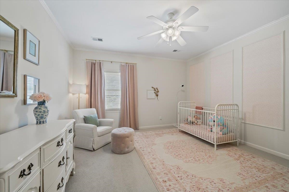 9455 Johnson Rd Extension Germantown, TN 38139 - Photo 27 of 40 Bedroom with a ceiling fan, light carpet, a crib, and ornamental molding