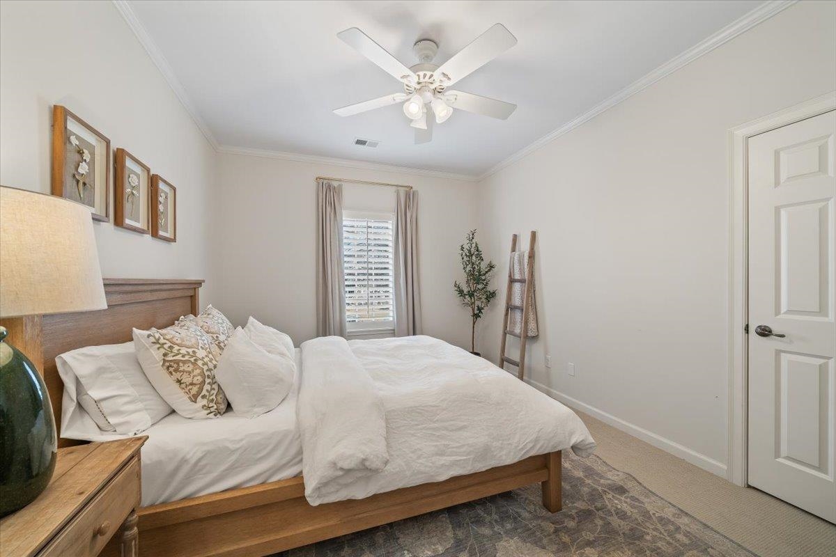 9455 Johnson Rd Extension Germantown, TN 38139 - Photo 29 of 40 Carpeted bedroom featuring ornamental molding and a ceiling fan