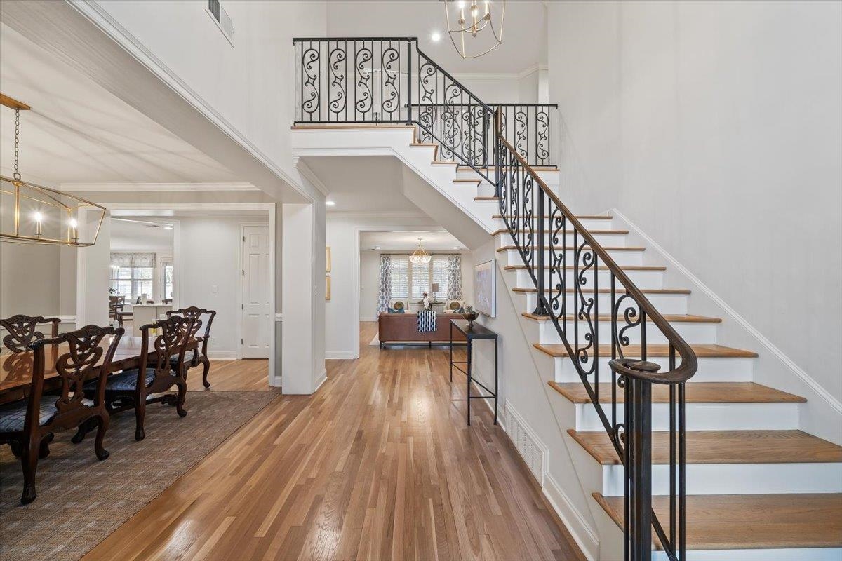 9455 Johnson Rd Extension Germantown, TN 38139 - Photo 5 of 40 Entrance foyer featuring hanging lights, crown molding, light wood-type flooring, a high ceiling, and healthy amount of natural light