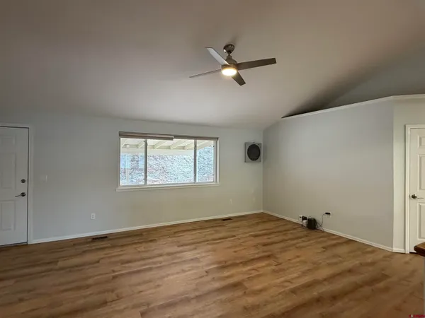 a view of a room with wooden floor and windows