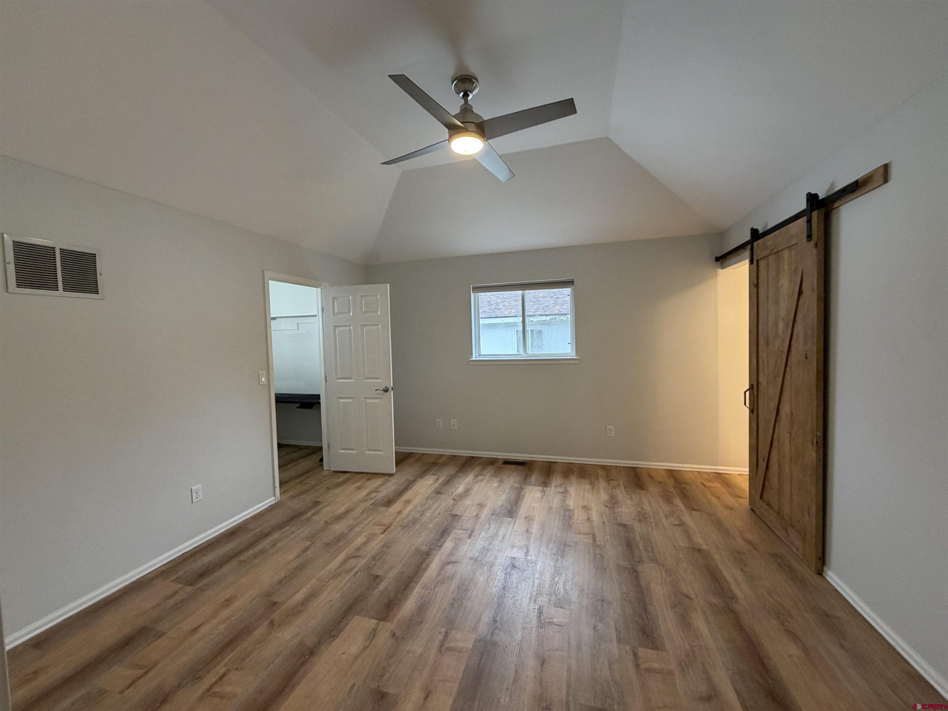 188 Bert Street Delta, CO 81416 - Photo 13 of 36 a view of an empty room with wooden floor and a window