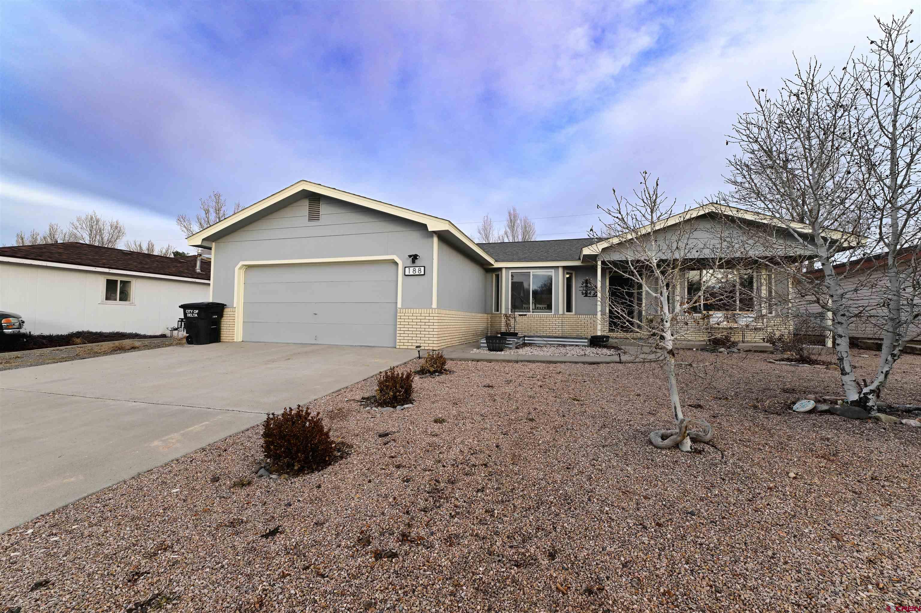 188 Bert Street Delta, CO 81416 - Photo 2 of 36 a front view of a house with a yard