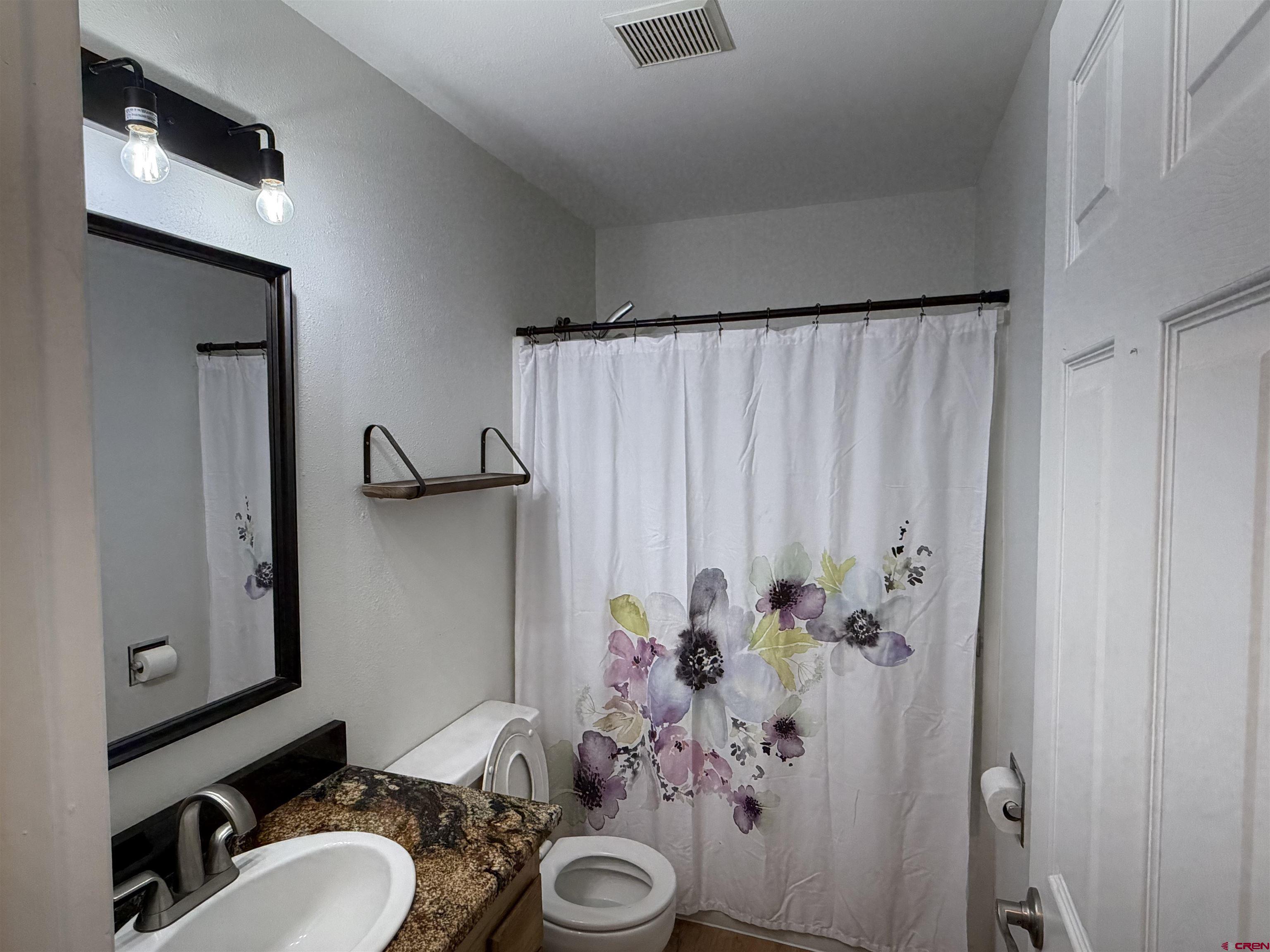 188 Bert Street Delta, CO 81416 - Photo 24 of 36 a bathroom with a sink and a mirror