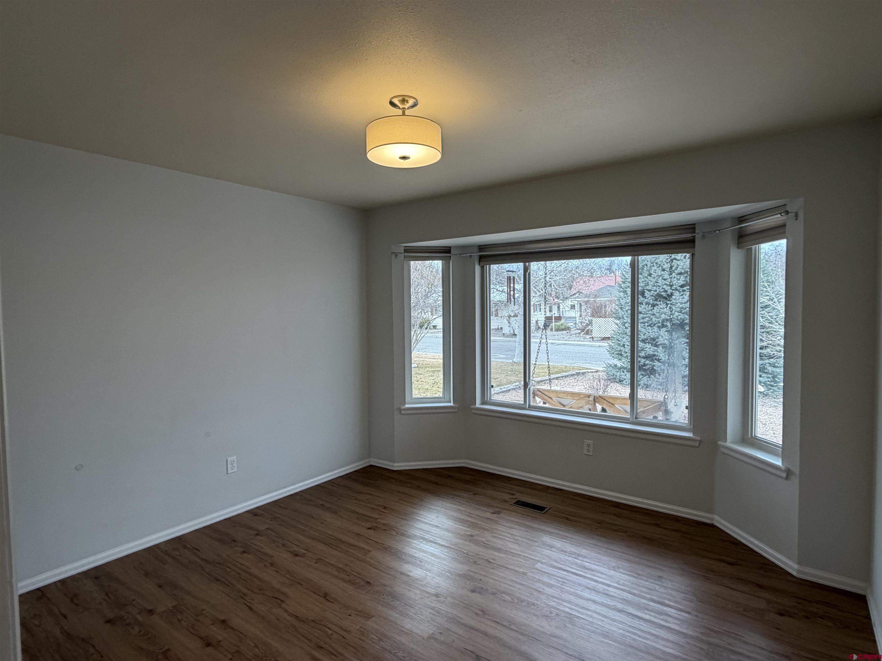 188 Bert Street Delta, CO 81416 - Photo 26 of 36 a view of an empty room with wooden floor and a window