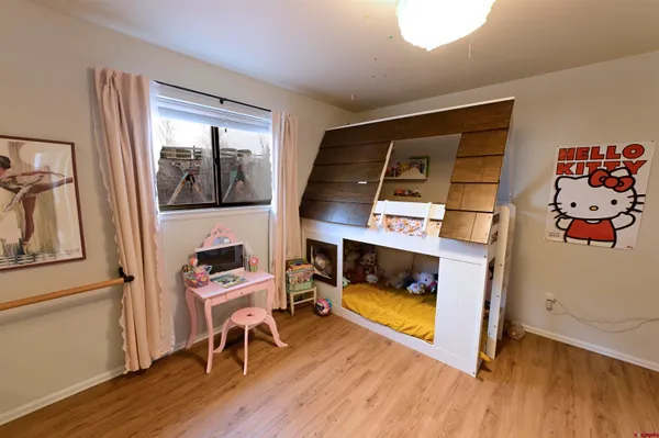 a room with wooden floor and furniture