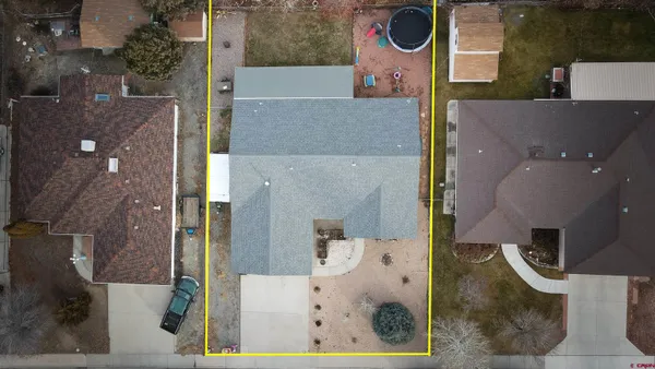 an aerial view of a house with a yard