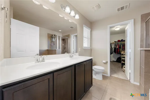 a bathroom with a sink vanity granite and a toilet
