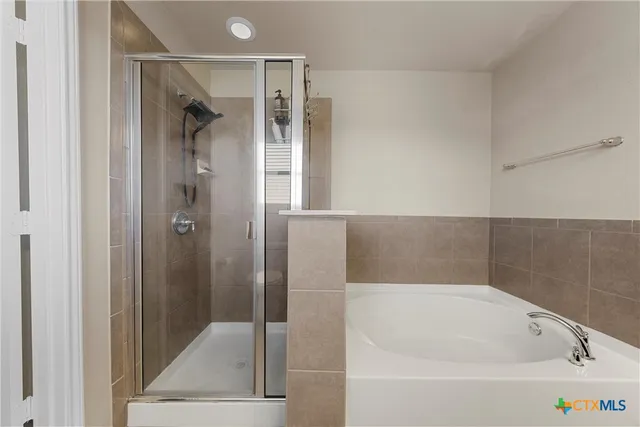 a bathroom with a bathtub and a shower