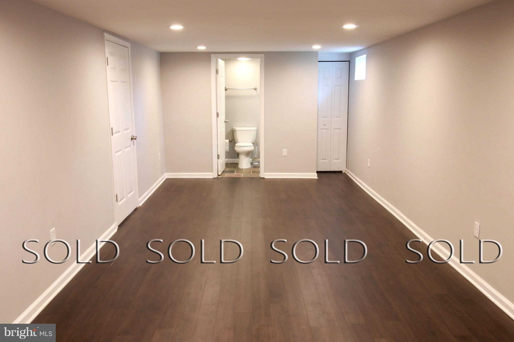 7402 Rockridge Road Baltimore, MD 21208 - Photo 22 of 30 a view of a room with a wooden floor