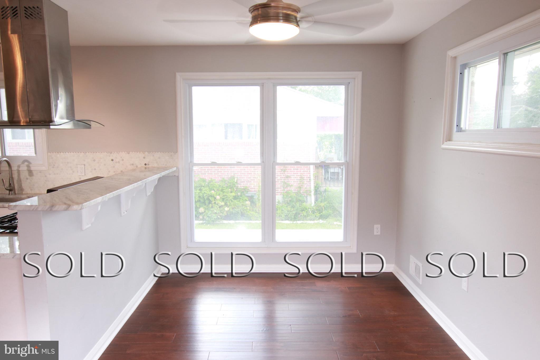 7402 Rockridge Road Baltimore, MD 21208 - Photo 5 of 30 a view of a room with wooden floor and windows