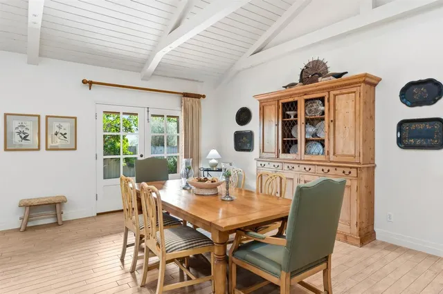 a view of a dining room with furniture wooden floor and a flat screen tv
