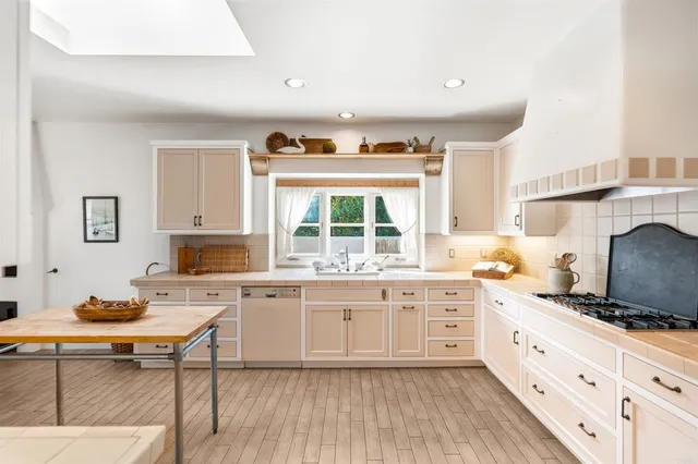 a kitchen with a stove a refrigerator and a stove top oven