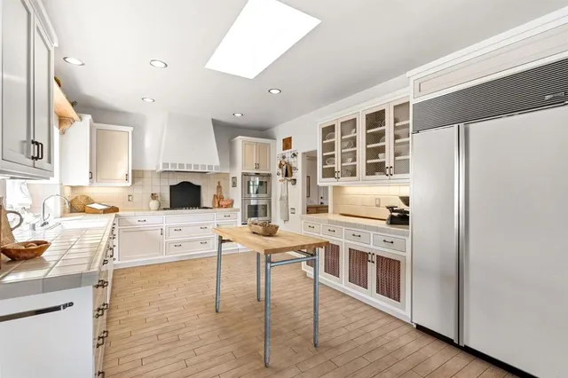 a bedroom with furniture and a large window