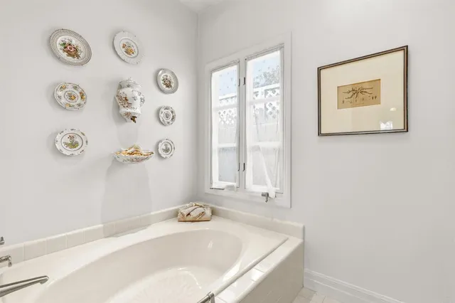 a bathroom with a granite countertop sink a toilet and shower curtain