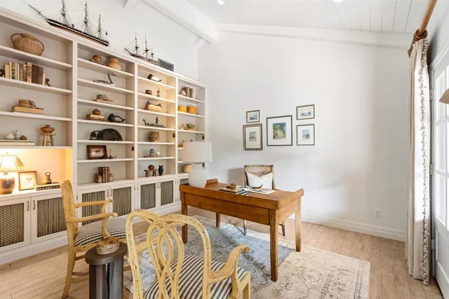 a view of a patio with table and chairs potted plants with large tree