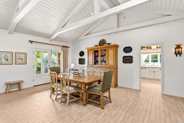a kitchen with white cabinets and sink