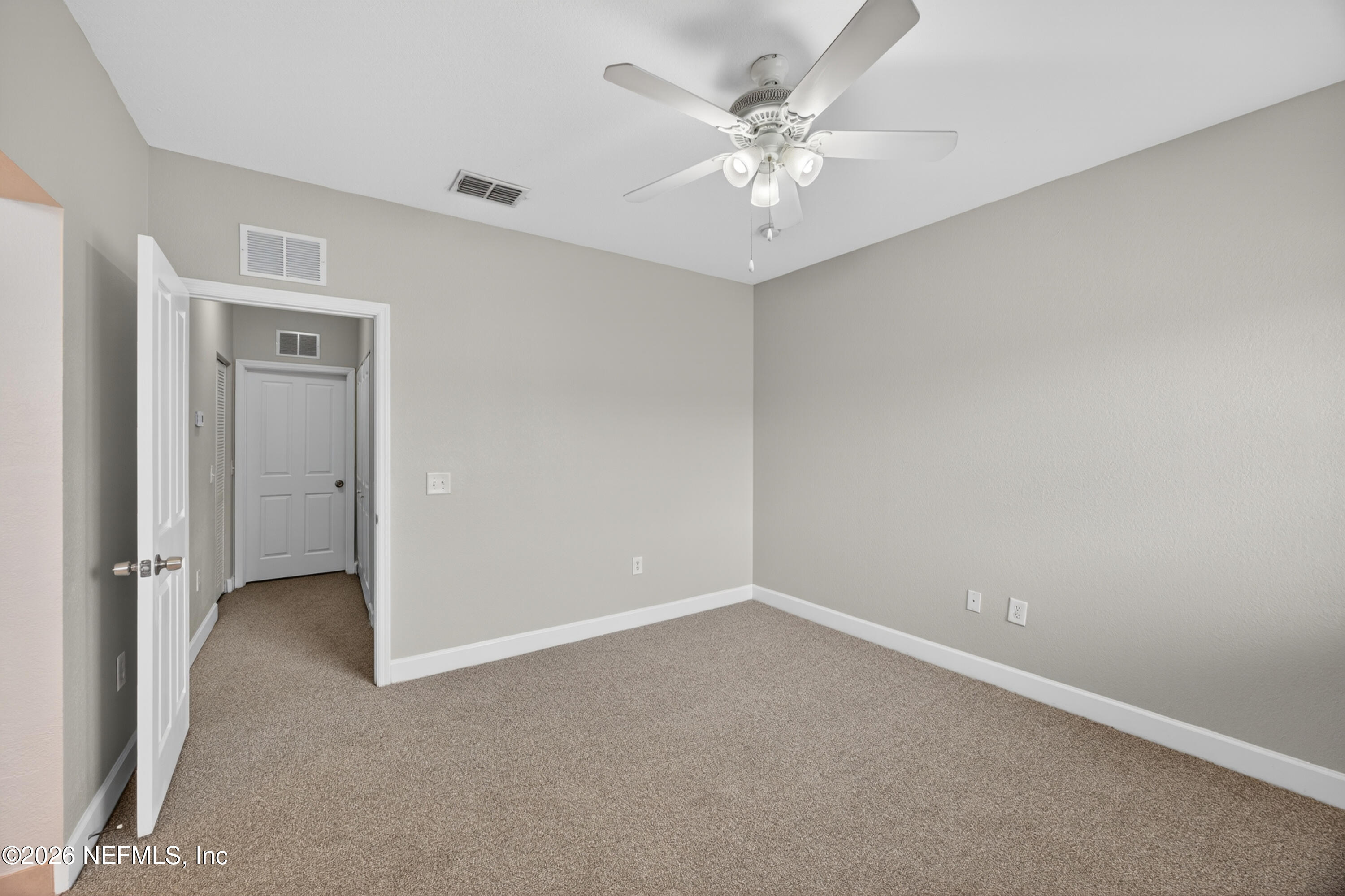 9745 Touchton Road, Unit 1224 Jacksonville, FL 32246 - Photo 12 of 22 an empty room with a ceiling fan and a window