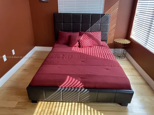 a bedroom with a bed and a black white wall
