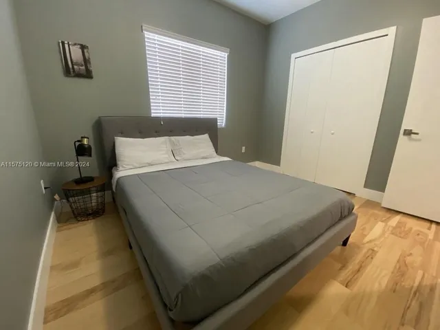 a bed sitting in a bedroom next to a window