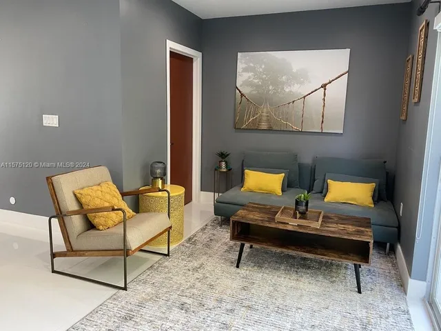 a view of a room with furniture and wooden floor