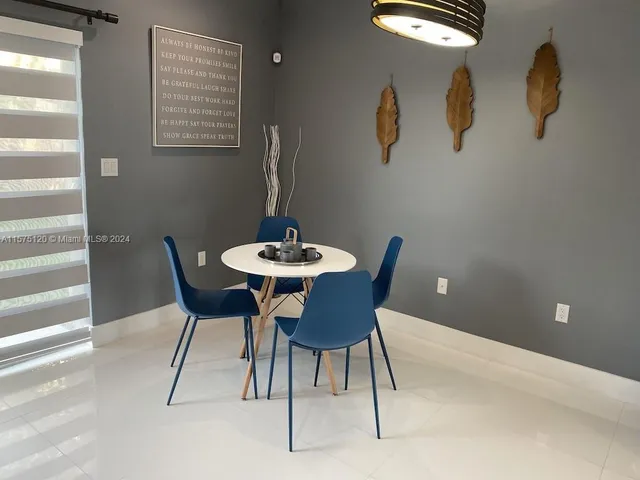 a reading room with furniture and rug