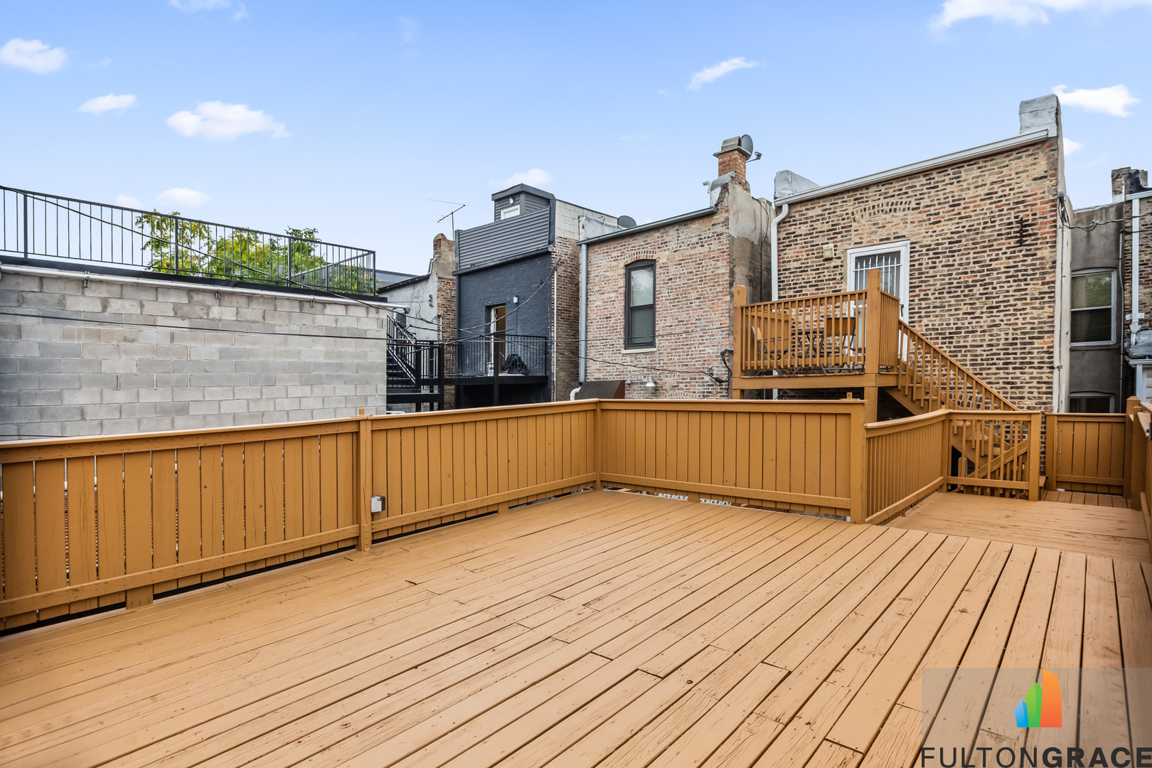 2744 West Warren Boulevard, Unit 1 Chicago, IL 60612 - Photo 13 of 15 a view of a balcony with wooden floor and iron stairs
