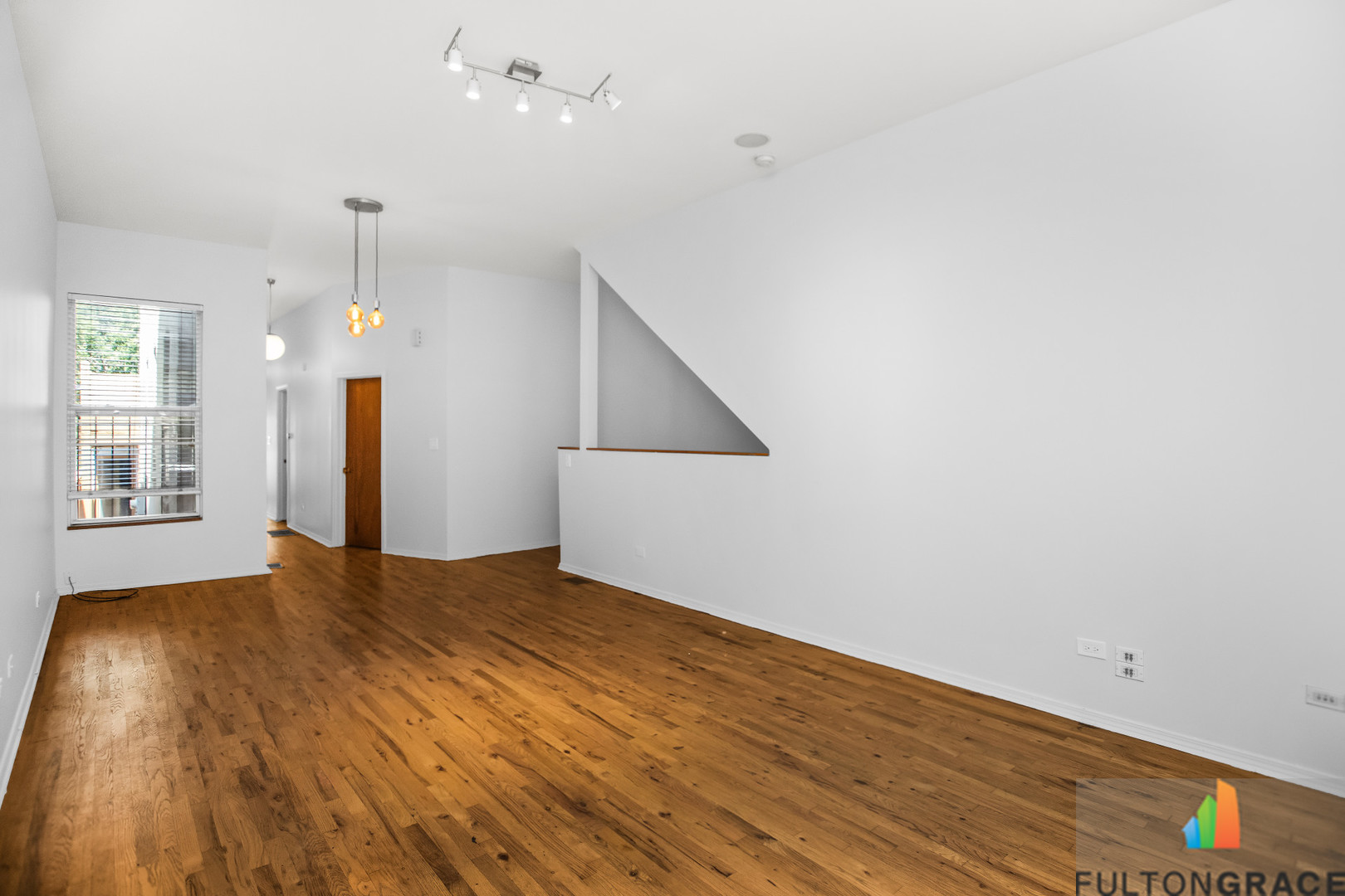 2744 West Warren Boulevard, Unit 1 Chicago, IL 60612 - Photo 2 of 15 an empty room with wooden floor and windows