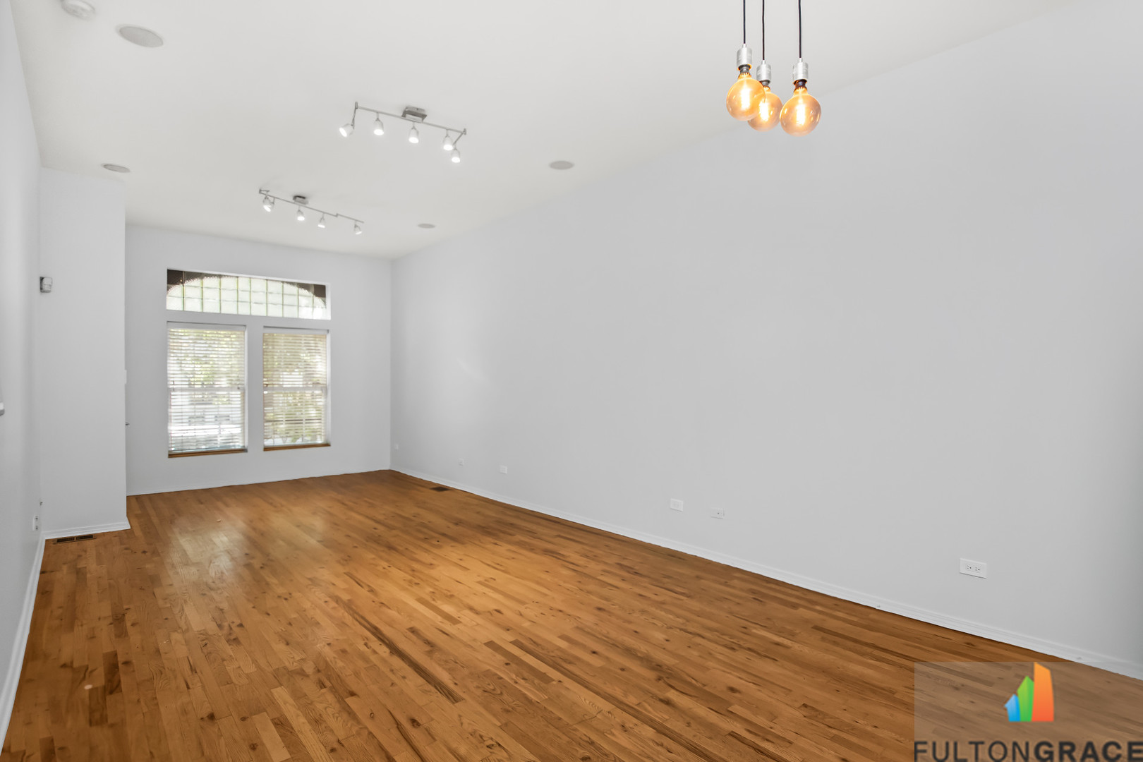 2744 West Warren Boulevard, Unit 1 Chicago, IL 60612 - Photo 3 of 15 an empty room with wooden floor and window