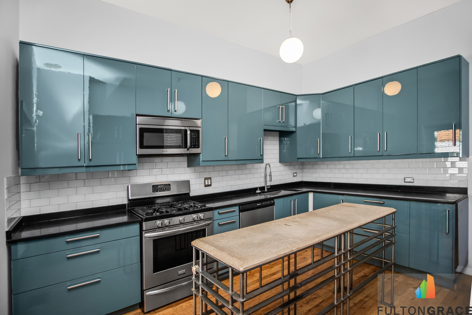 2744 West Warren Boulevard, Unit 1 Chicago, IL 60612 - Photo 4 of 15 a kitchen with stainless steel appliances granite countertop a stove a sink and a microwave