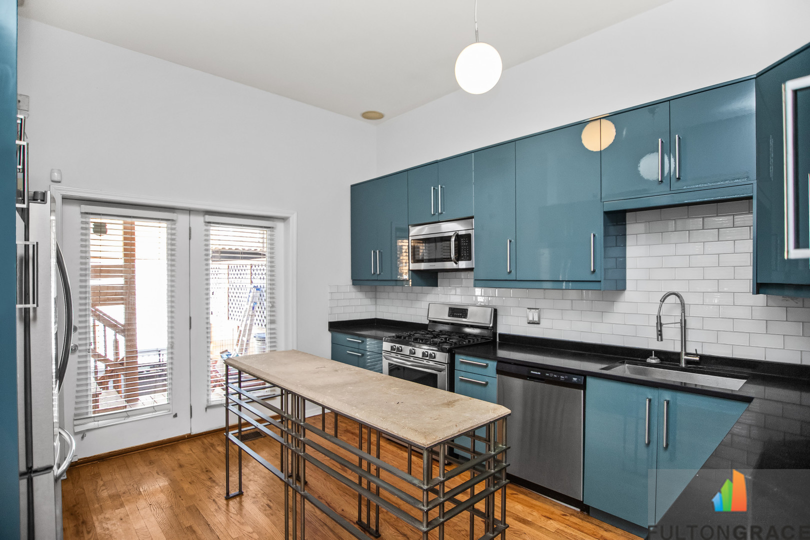 2744 West Warren Boulevard, Unit 1 Chicago, IL 60612 - Photo 5 of 15 a kitchen with stainless steel appliances granite countertop a sink stove and cabinets