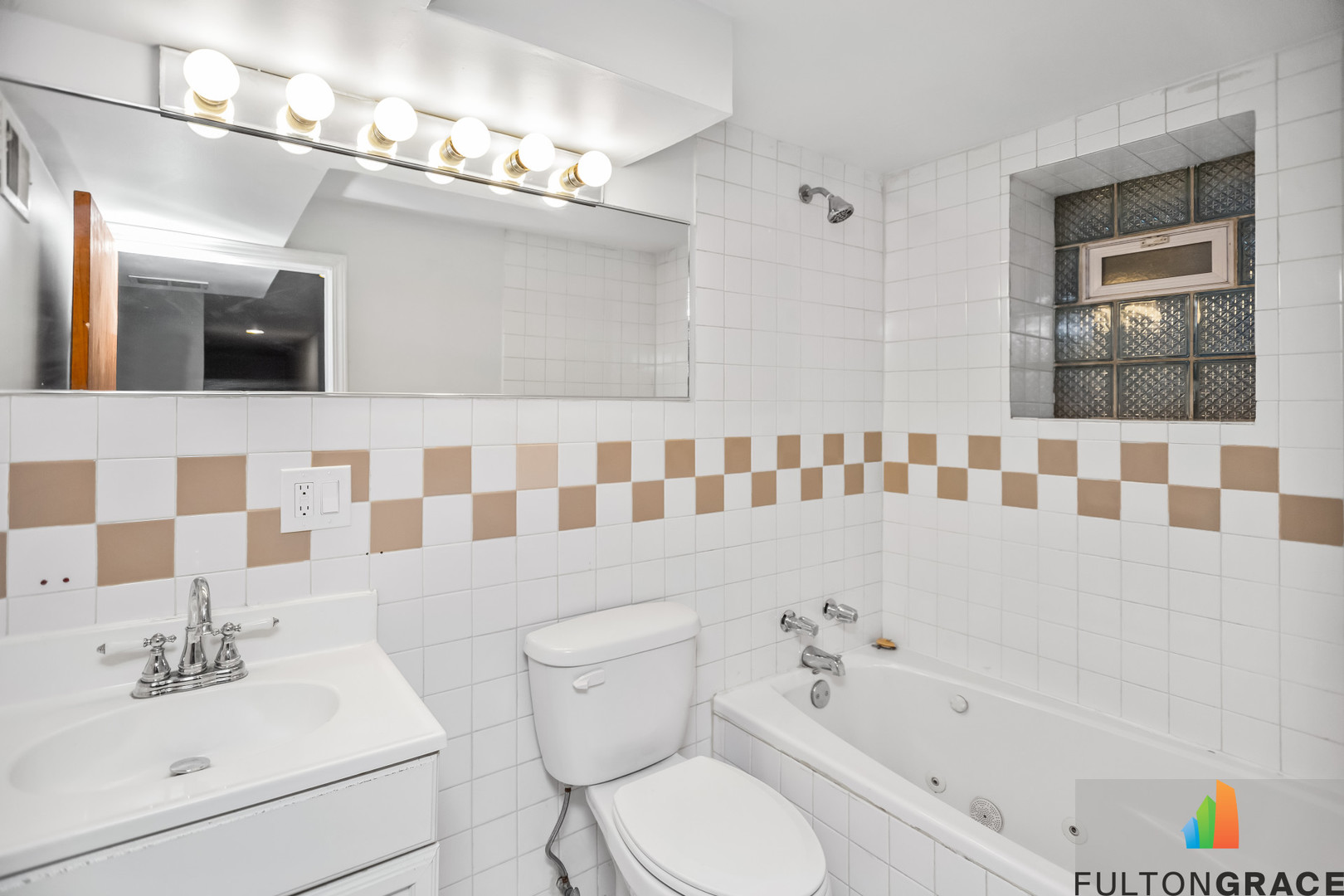 2744 West Warren Boulevard, Unit 1 Chicago, IL 60612 - Photo 6 of 15 a bathroom with a bathtub sink vanity mirror and toilet