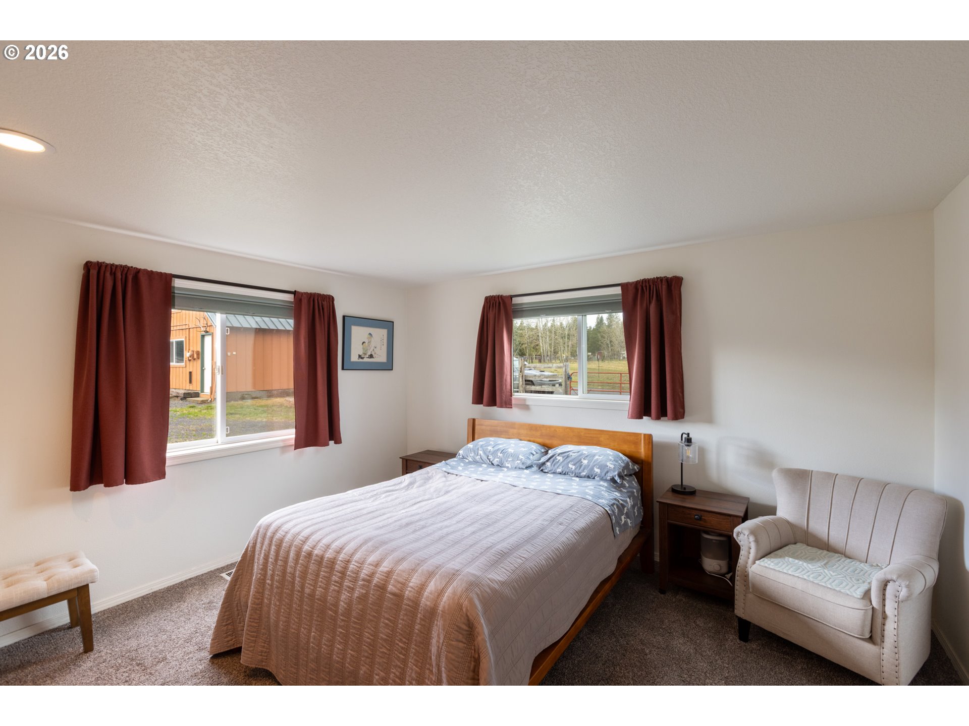 56 Jennings Road Trout Lake, WA 98650 - Photo 14 of 42 a bedroom with a large bed and a couch