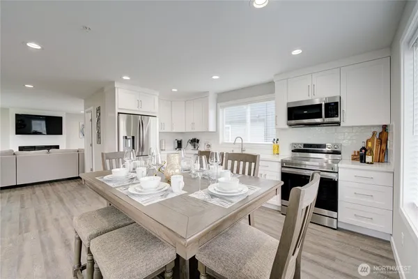 a view of a hallway with wooden floor and stairs
