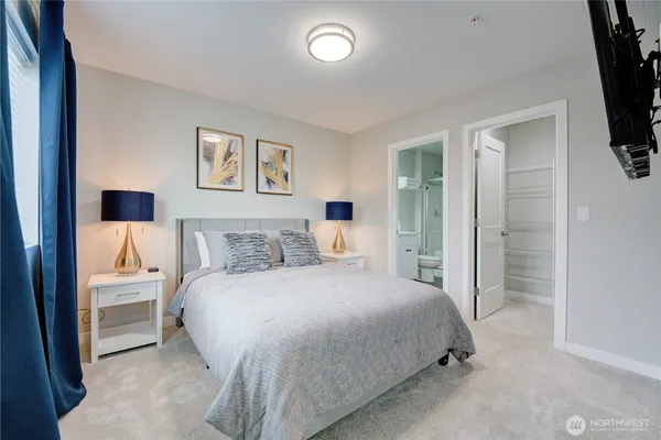 a bedroom with a bed and a night stand