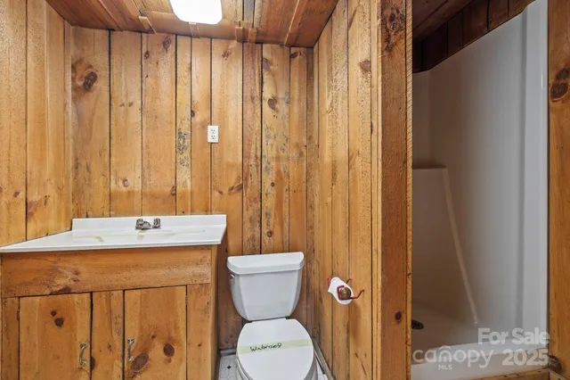 a bathroom with a sink a toilet and shower curtain