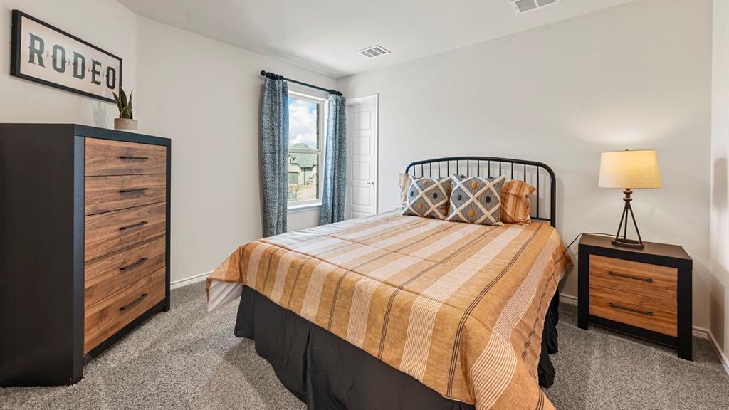 1305 Rusted Rail Drive Princeton, TX 75407 - Photo 11 of 35 a bedroom with a bed and a closet