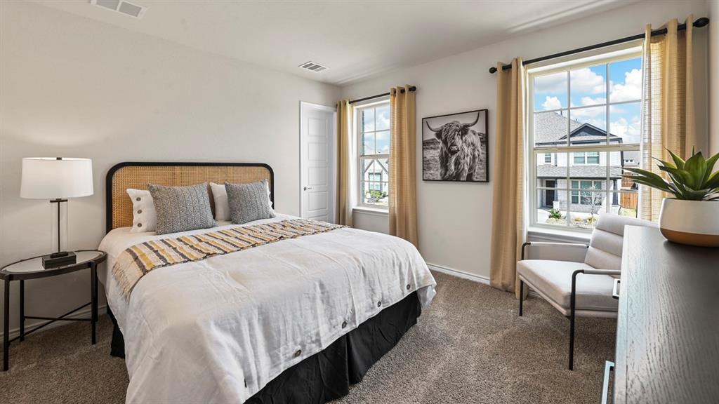 1305 Rusted Rail Drive Princeton, TX 75407 - Photo 12 of 35 a bedroom with a large bed and a couch