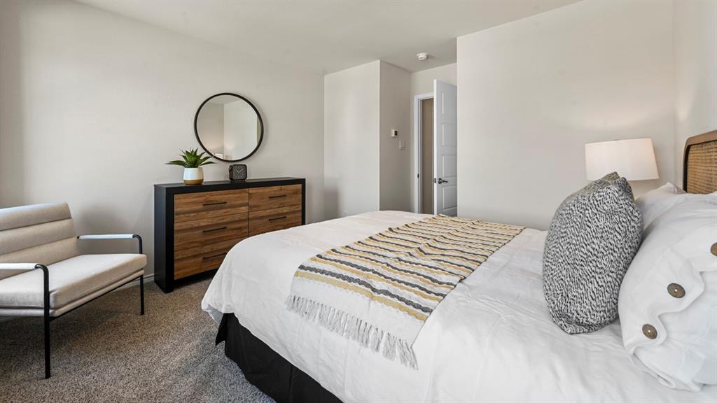 1305 Rusted Rail Drive Princeton, TX 75407 - Photo 13 of 35 a bedroom with a large bed and closet
