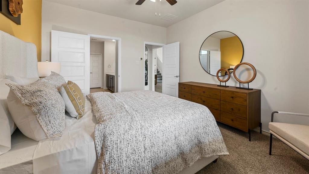 1305 Rusted Rail Drive Princeton, TX 75407 - Photo 16 of 35 a bedroom with a bed and dresser with mirror