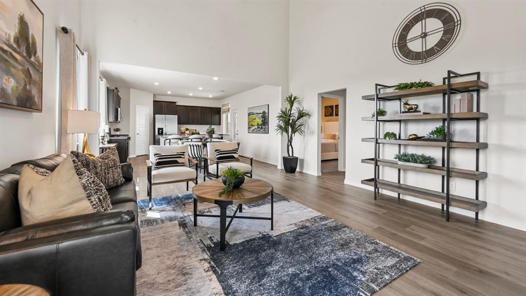 1305 Rusted Rail Drive Princeton, TX 75407 - Photo 25 of 35 a living room with furniture a rug and a wall painting