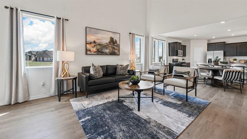 1305 Rusted Rail Drive Princeton, TX 75407 - Photo 26 of 35 a living room with furniture wooden floor and a large window