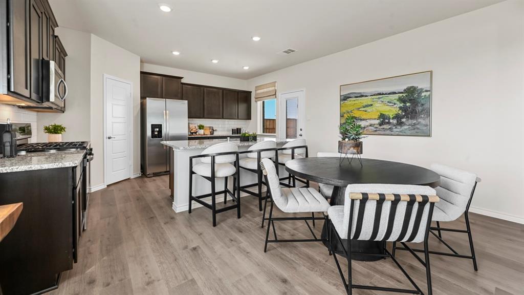 1305 Rusted Rail Drive Princeton, TX 75407 - Photo 30 of 35 a view of a dining room with furniture and wooden floor