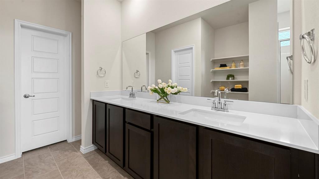 1305 Rusted Rail Drive Princeton, TX 75407 - Photo 4 of 35 a bathroom with a double vanity sink and a mirror