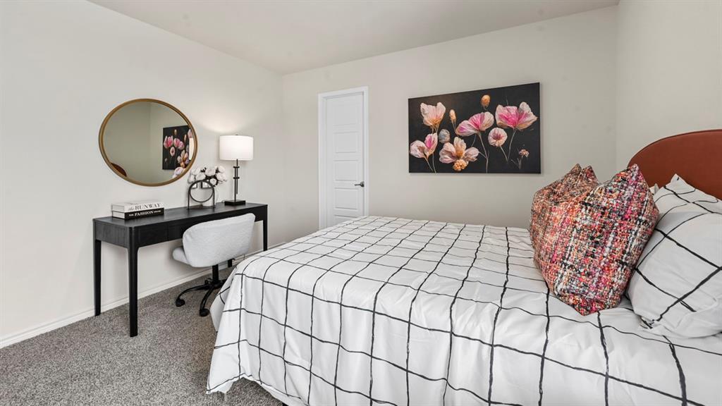 1305 Rusted Rail Drive Princeton, TX 75407 - Photo 9 of 35 a bedroom with a bed a mirror and a potted plant