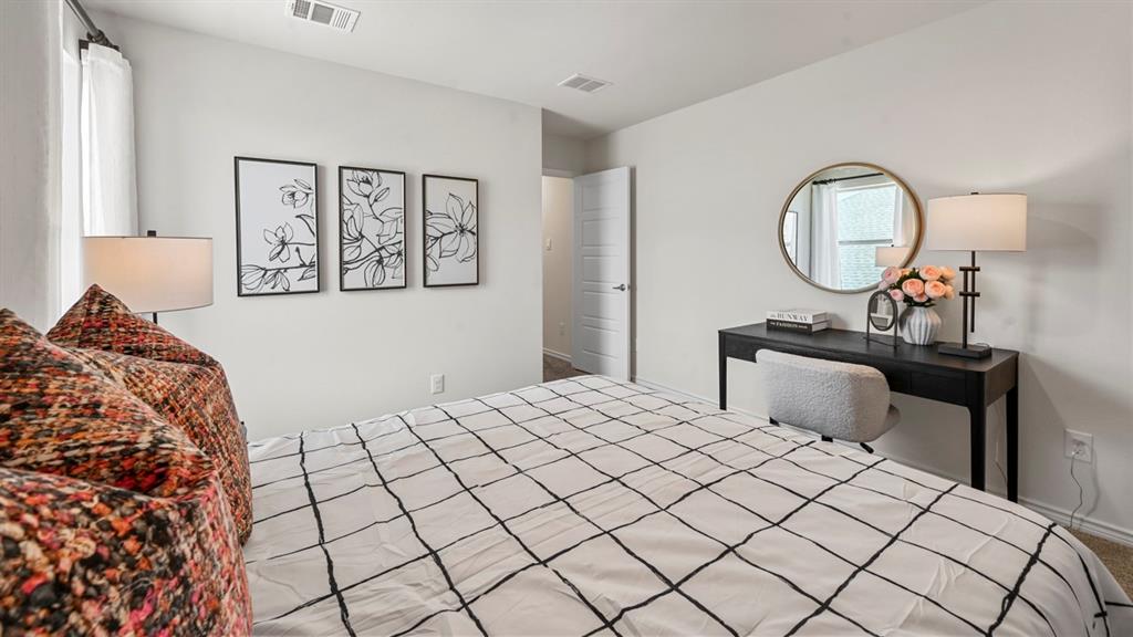 1305 Rusted Rail Drive Princeton, TX 75407 - Photo 10 of 35 a bedroom with a bed and a chandelier