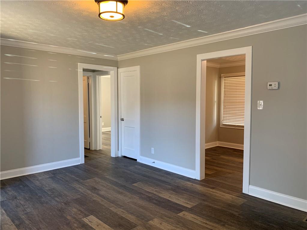 1261 Concord Road Southeast Smyrna, GA 30080 - Photo 10 of 50 an empty room with wooden floor and closet