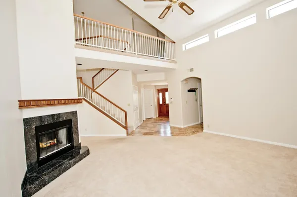 a view of a livingroom with wooden floor and a fireplace